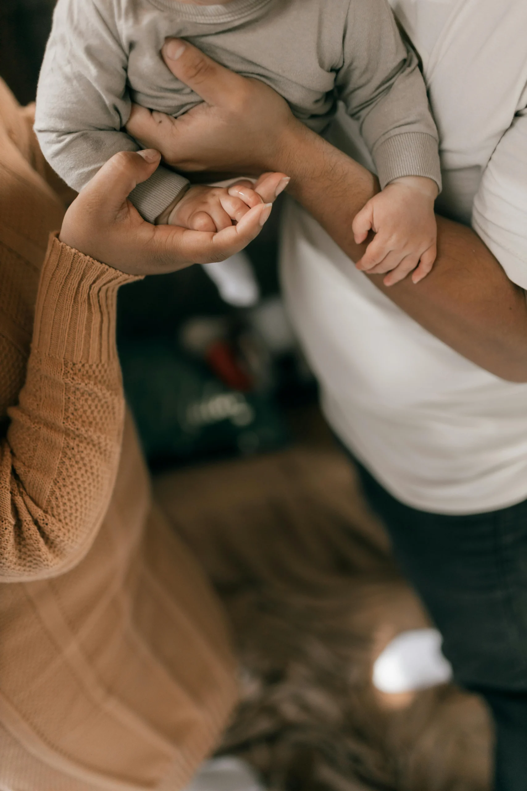 Tender Family Moment Holding Baby at Home
