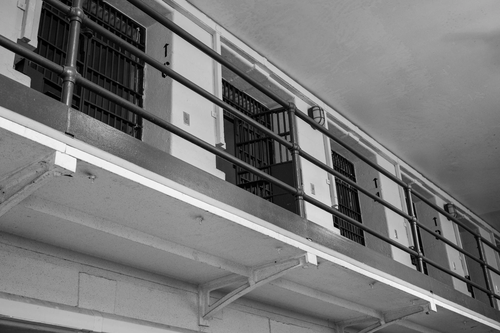 A black and white photo of a prison cell